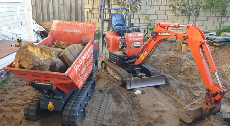 digger-dumper-bricks Mini excavator removing broken bricks
